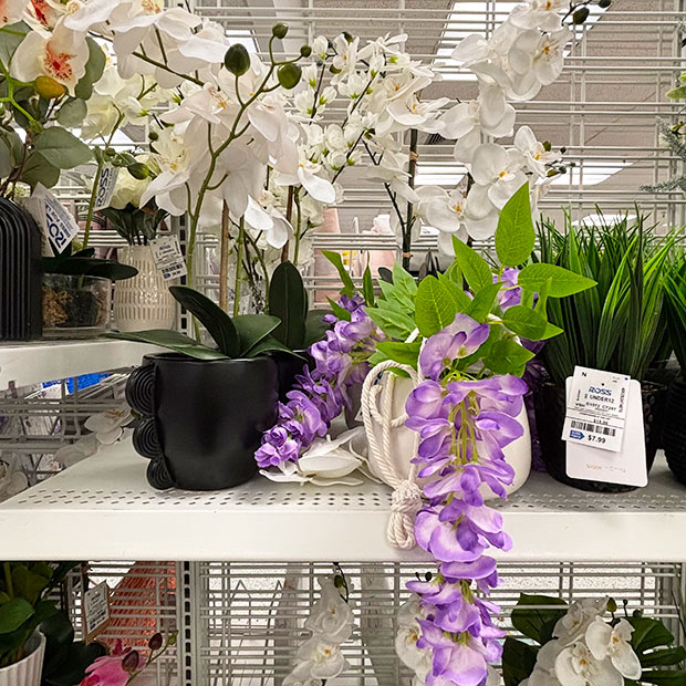 Purple and white faux floral arrangements and in planters, found in store at Ross.