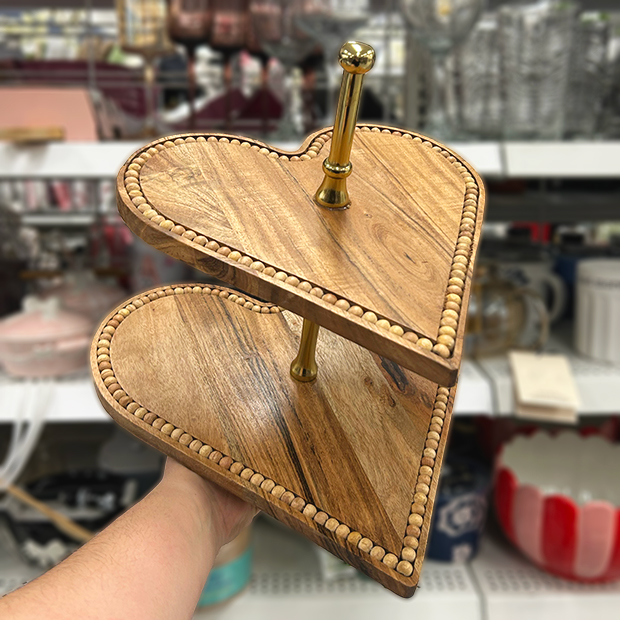 Two-tier heart-shaped wooden serving stand with decorative beaded edges.