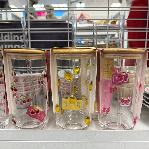 Clear glass tumblers with fruit and bow patterns.
