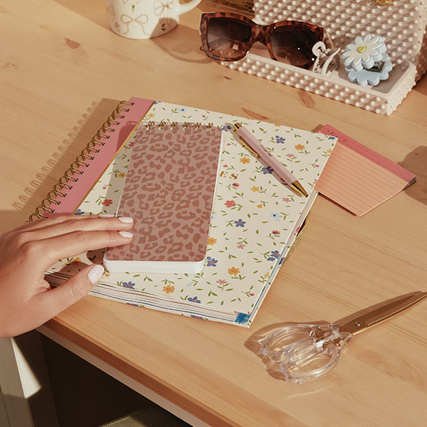 Journal and supplies on a desk.